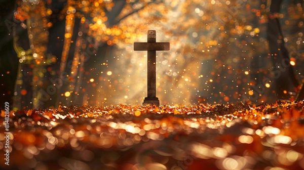 Fototapeta A Christian cross at the end of a long, wooded path, with sunlight streaming through the autumn leaves, casting scattered golden bokeh spots that create a pathway leading to the cross.