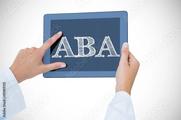 Obraz Aba against doctor using tablet pc
