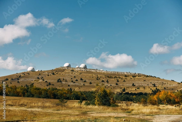 Fototapeta Three powerful telescopes capturing the beauty of the cosmos from a remote hilltop observatory on a clear day