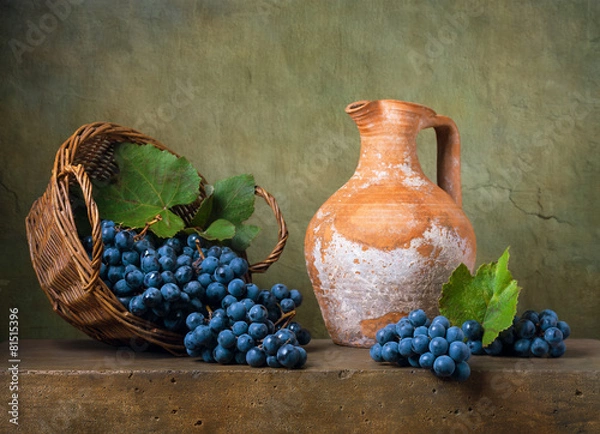 Fototapeta Still life with grapes on a basket and jug