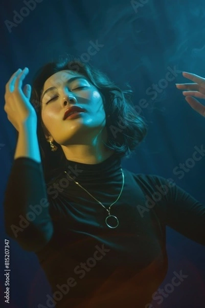 Fototapeta A woman in a black turtleneck is dancing surrounded by flowers. Liberty. Pleasure. Spring. Relax. Rest. Long awaited. shamanism.