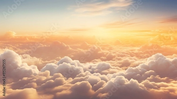 Fototapeta Majestic overhead view of fluffy clouds under the golden light of sunset, ideal for use in travel and lifestyle advertising.