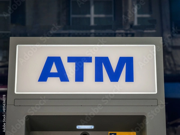 Obraz Silver automatic teller machine hanging on a gray concrete wall