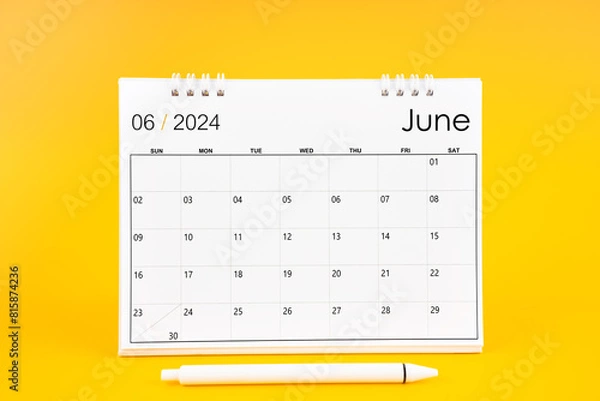 Fototapeta June 2024, Monthly desk calendar for 2024 year and pen on yellow background.