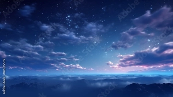 Fototapeta A tranquil scene showing a star-filled night sky above silhouetted misty mountainous landscape during twilight
