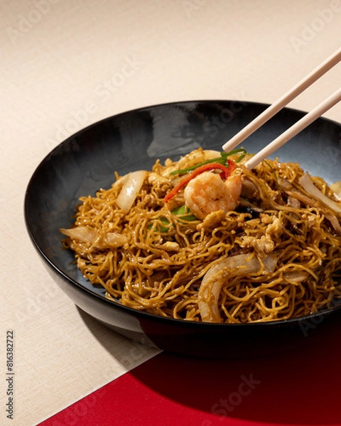 Fototapeta Mi Goreng is a noodle dish cooked with stir-fried vegetables typical of Hong Kong