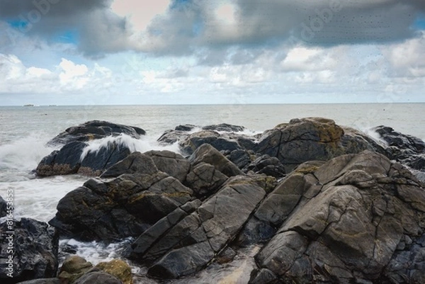 Fototapeta Image of a wave crashing on the rock