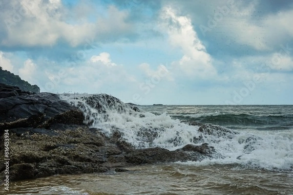 Fototapeta Image of a wave crashing on the rock