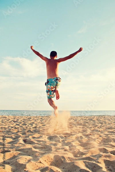 Obraz man jumping at beach - summer holidays