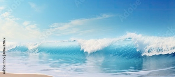 Fototapeta Copy space image of a serene ocean wave gently crashing onto a pristine sandy beach creating a mesmerizing background