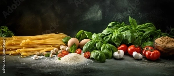 Fototapeta Ingredients for uncooked tagliatelle pasta include ground spinach powder and whole wheat flour as depicted in this copy space image