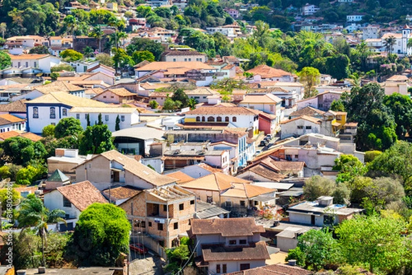 Fototapeta Partial view of the city of Sabará, Brazil. Streets, bridge, mountain, trees and blue sky with clouds.