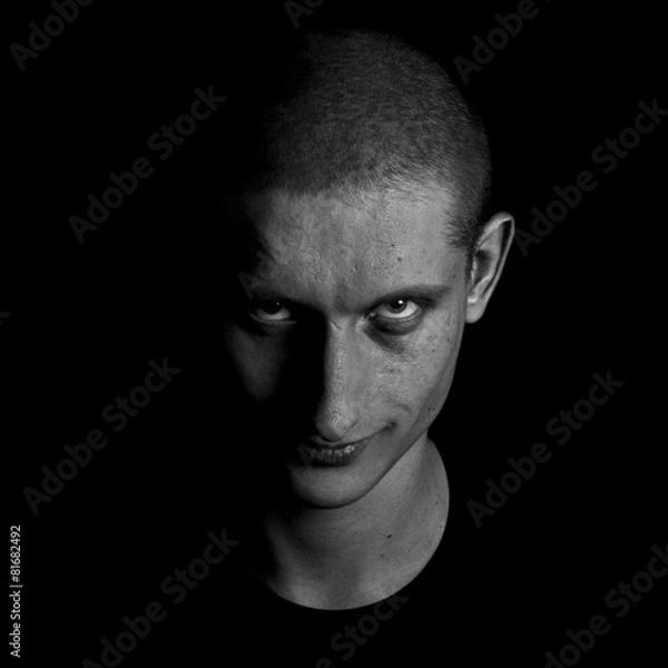 Obraz Grimly grinning man looks into the camera