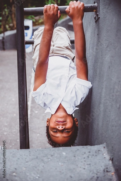 Obraz boy hanging upside down on his hands