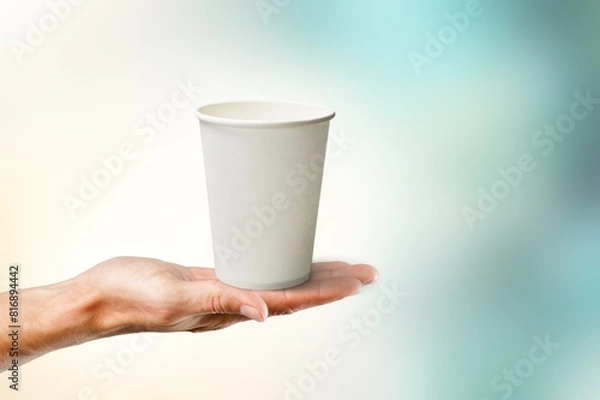 Fototapeta Woman hand hold takeaway paper cup of coffee
