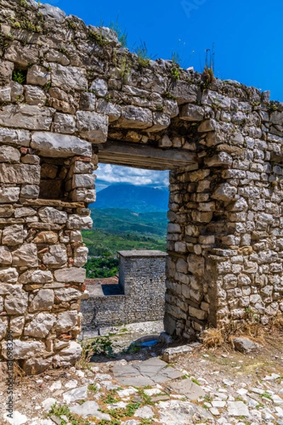 Fototapeta A view through a doorway in the castle above the city of Berat, Albania in summertime