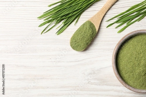 Fototapeta Wheat grass powder and fresh sprouts on white wooden table, flat lay. Space for text