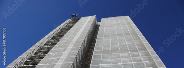 Fototapeta scaffolding structure on a construction site to install energy-saving panels using funds allocated by the European Union