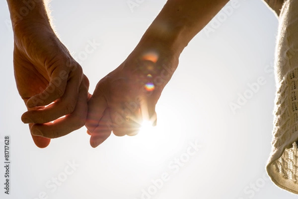 Obraz Couple Hands Holding Together with Sun Rays