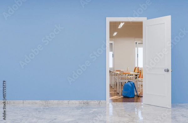 Fototapeta Open door to classroom with desks and backpacks, blue wall and copy space