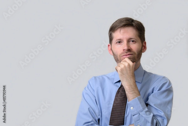 Obraz Serious business man with hand on chin