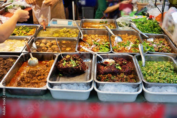 Obraz A table full of food with a The thai food is in many different dishes and is served in a buffet style