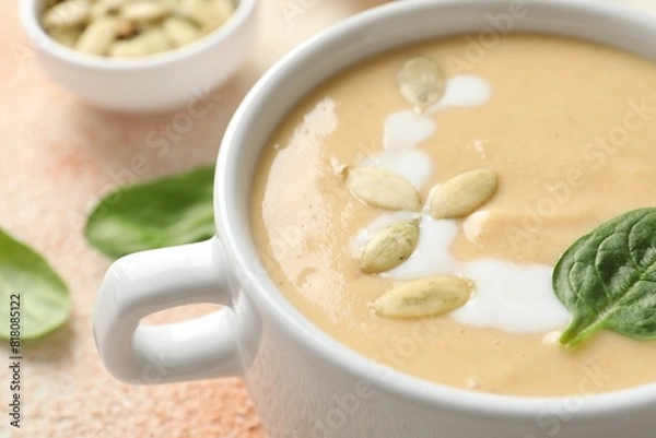 Fototapeta Healthy cream soup high in vegetable fats on color textured table, closeup