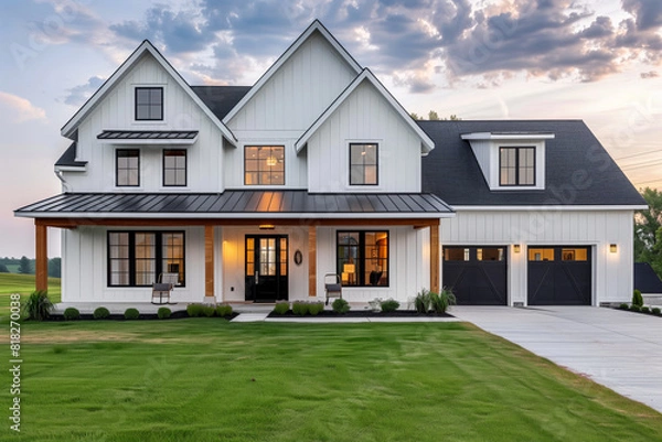 Obraz White house with black roof and garage