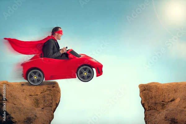 Obraz man in a car jumping a ravine