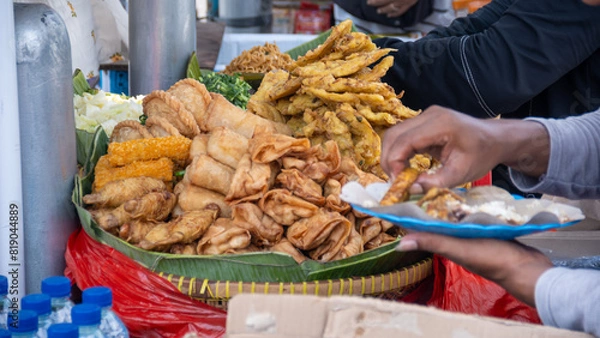 Fototapeta Gorengan is a typical snack from Indonesia. It usually consists of tempeh, tofu, cassava, and bananas. Gorengan is one of the people's favorite street foods in Indonesia