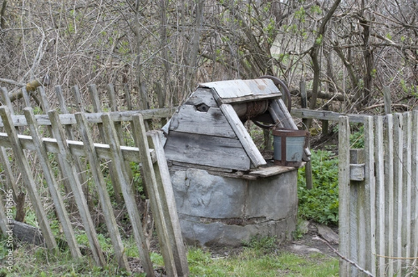 Fototapeta Old well for water on a cemetery