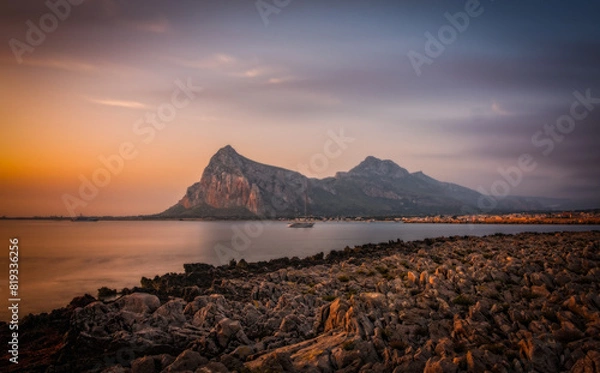 Fototapeta Sunrise on the paradise Tyrrhenian sea bay. San Vito lo Capo and Monte Monaco in far, Sicily, Italy. June 2023, long exposure picture