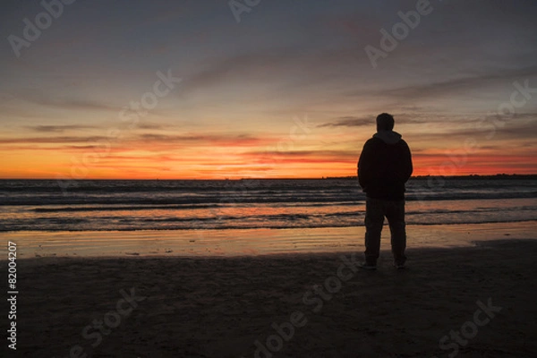Obraz Silhouette of man on a beautiful sunset on the beach