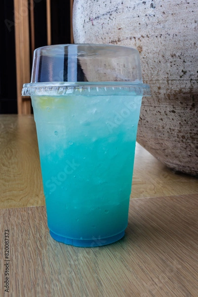 Obraz Refreshing Blue Drink with Yellow Fruit in Glass
