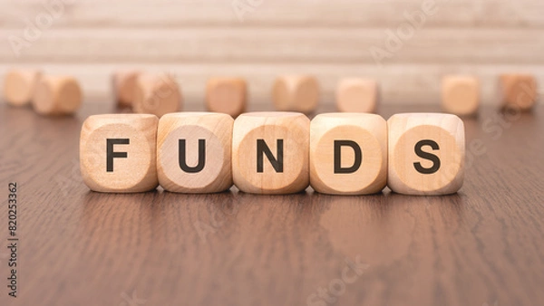 Fototapeta the text 'FUNDS' is written on wooden cubes on a brown background