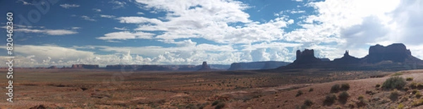 Fototapeta Monument valley wide panoramic view on sunny day, distant buttes and mesa rock formations, contrast contour