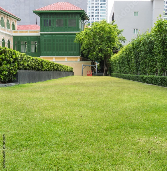 Obraz Green grass and cones with Asian style building