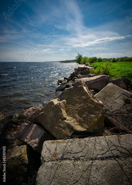 Fototapeta Large boulders line the shores of the St. Lawrence river
