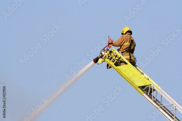 Obraz firefighter extinguishes fire