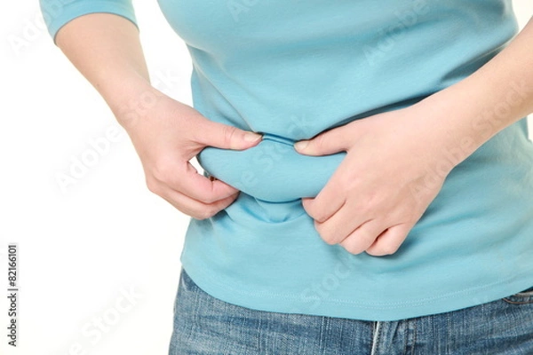Fototapeta お腹の贅肉をつまむ女性