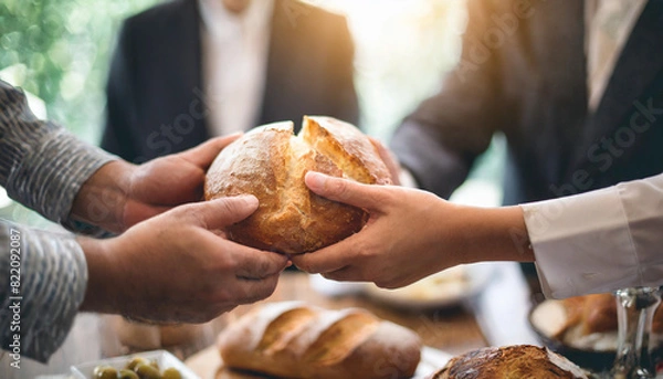 Fototapeta unity and spirituality as people share communion, breaking bread together.