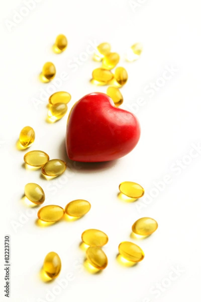 Fototapeta Red heart and cod liver oil, isolated on white