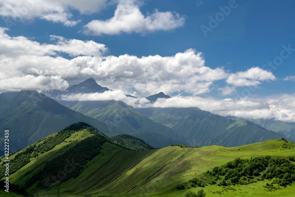 Fototapeta Clouds cover the peaks of the mountains. View of the Caucasus Mountains in Ingushetia, Russia