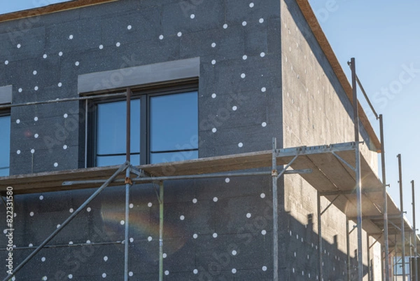 Fototapeta modern thermal insulation materials. building New House in process insulation of the wall of the house with layers Exterior covering in construction site.