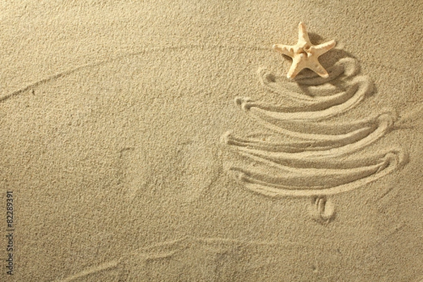 Obraz Christmass tree from shells on sand background