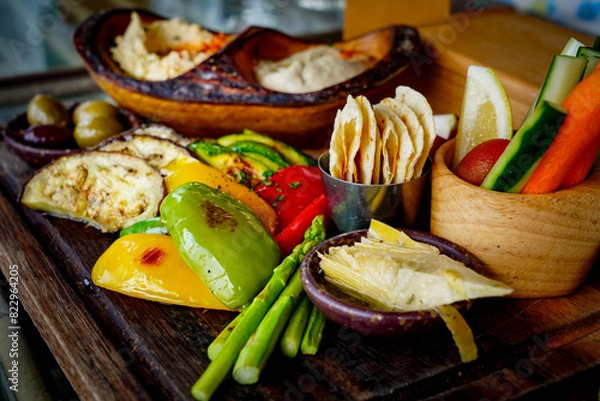 Fototapeta Mezze Plate. Whit Hummus, Olives, Crudites, Pita Bread, Baba Ghanoush. Various appetizing spanish mezze dishes.
