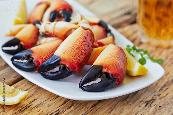 Fototapeta Boiled crab claws on a plate and beer