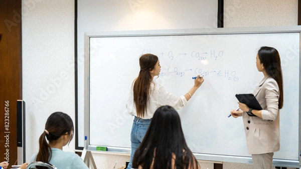 Fototapeta A group of people are in a classroom with a whiteboard