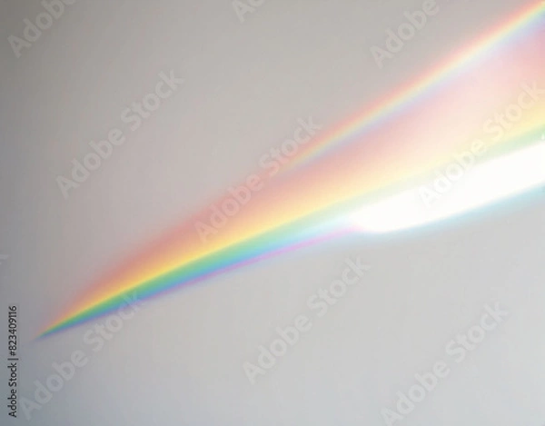 Fototapeta A texture overlay effect of blurred rainbow light refraction for photos and mockups. Organic diagonal holographic flare on a white wall. Realistic natural light effects.