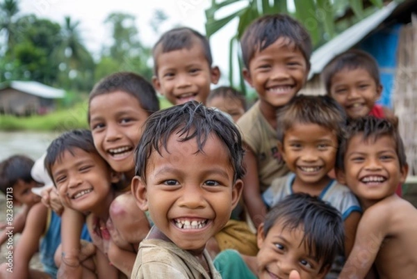 Fototapeta Group of asian kids smiling and looking at the camera in a village